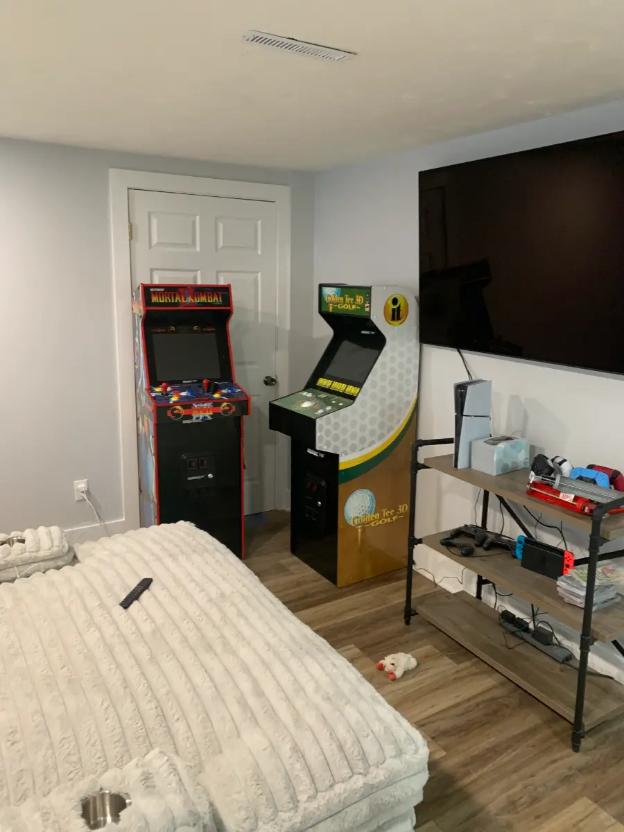 basement renovation with shiplap wall and gaming area, after