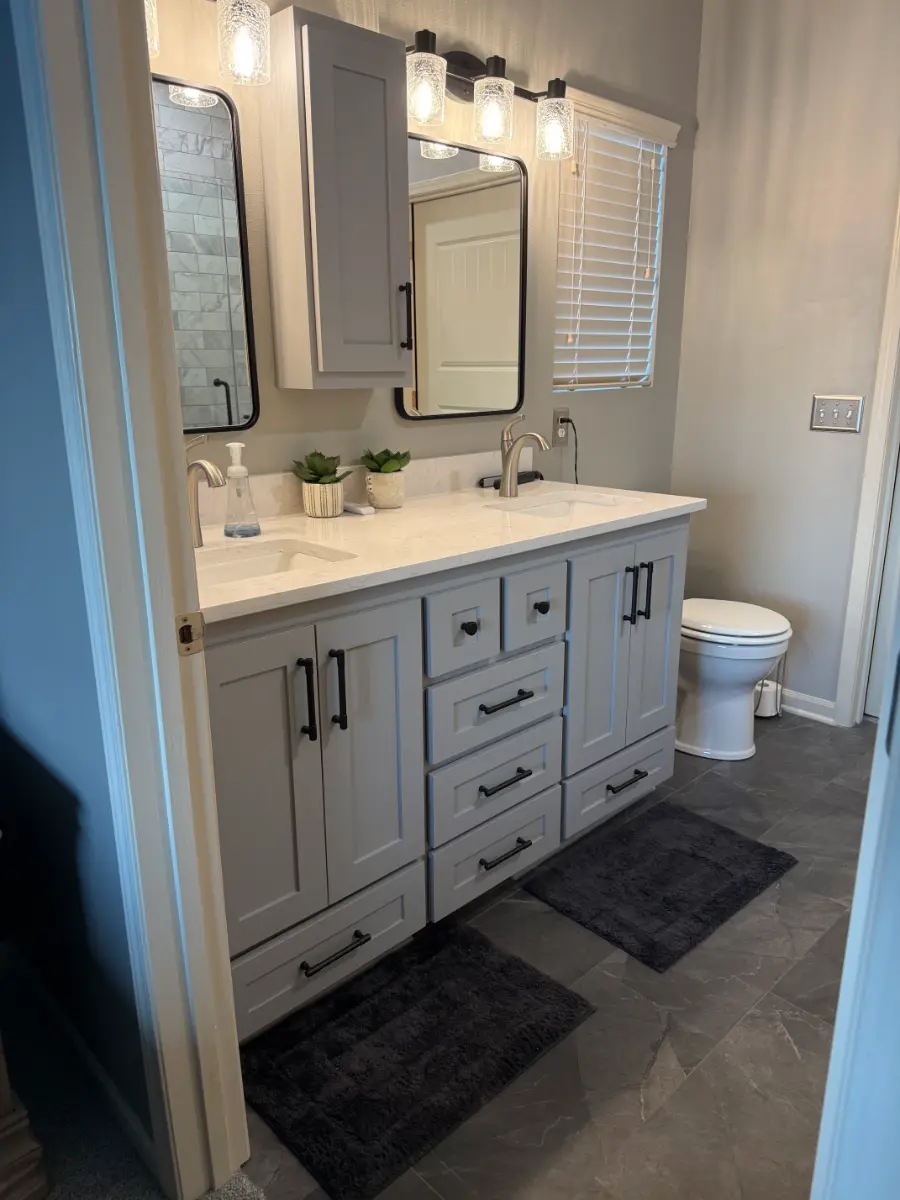 bathroom remodel with marble shower and double vanity, after