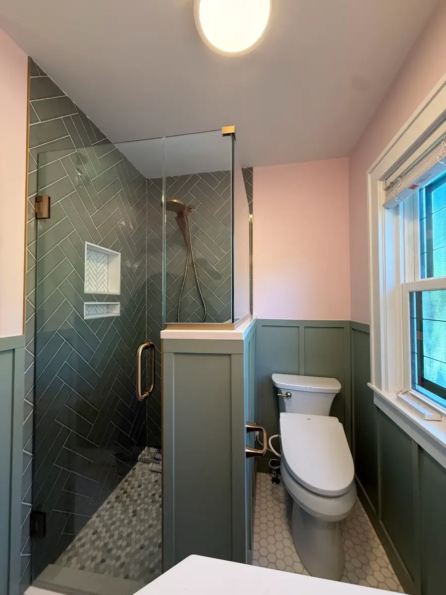 bathroom remodel with herringbone tile and sage wainscoting, after