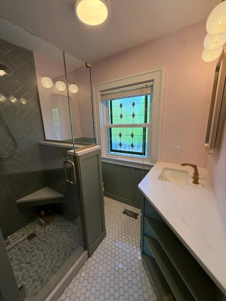 bathroom remodel with herringbone tile and sage wainscoting, after