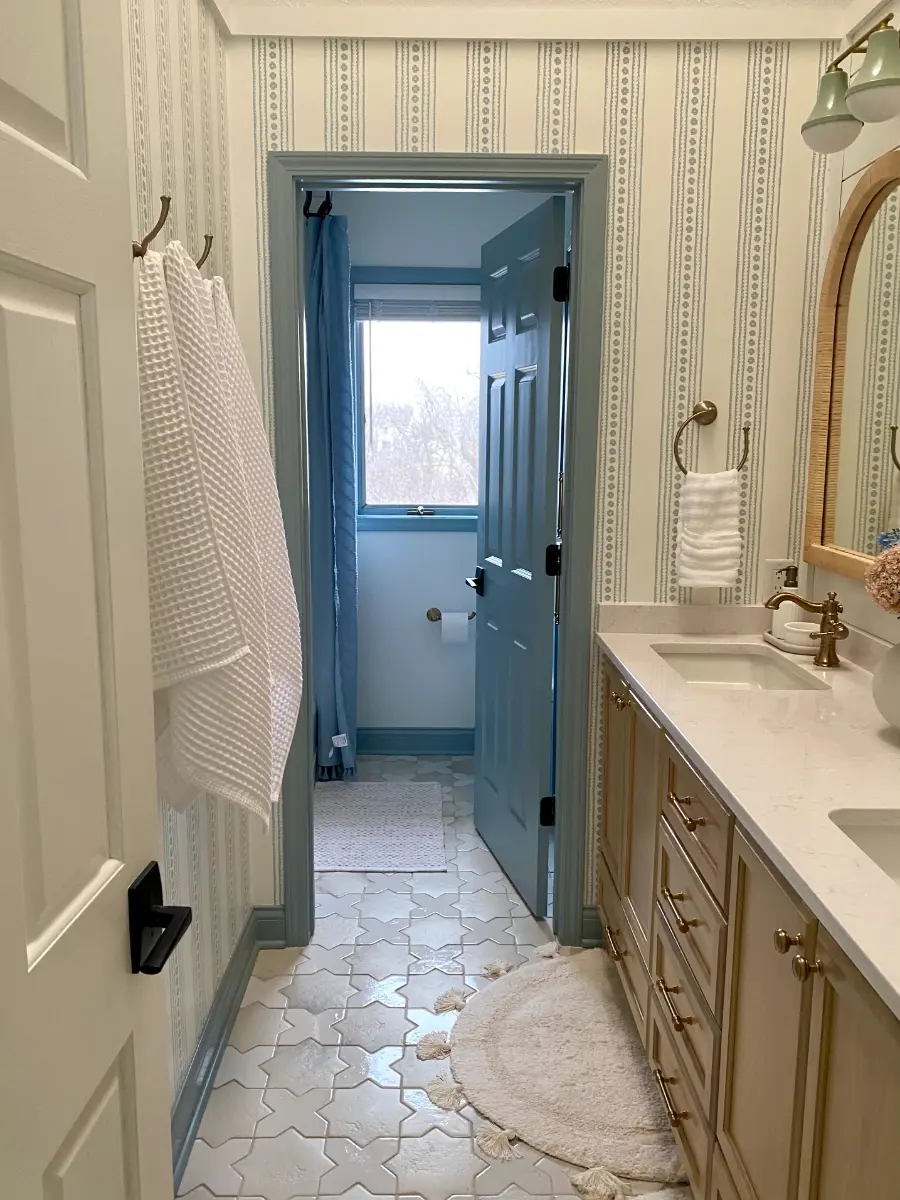 bathroom remodel with wood vanity and patterned tile floor, after