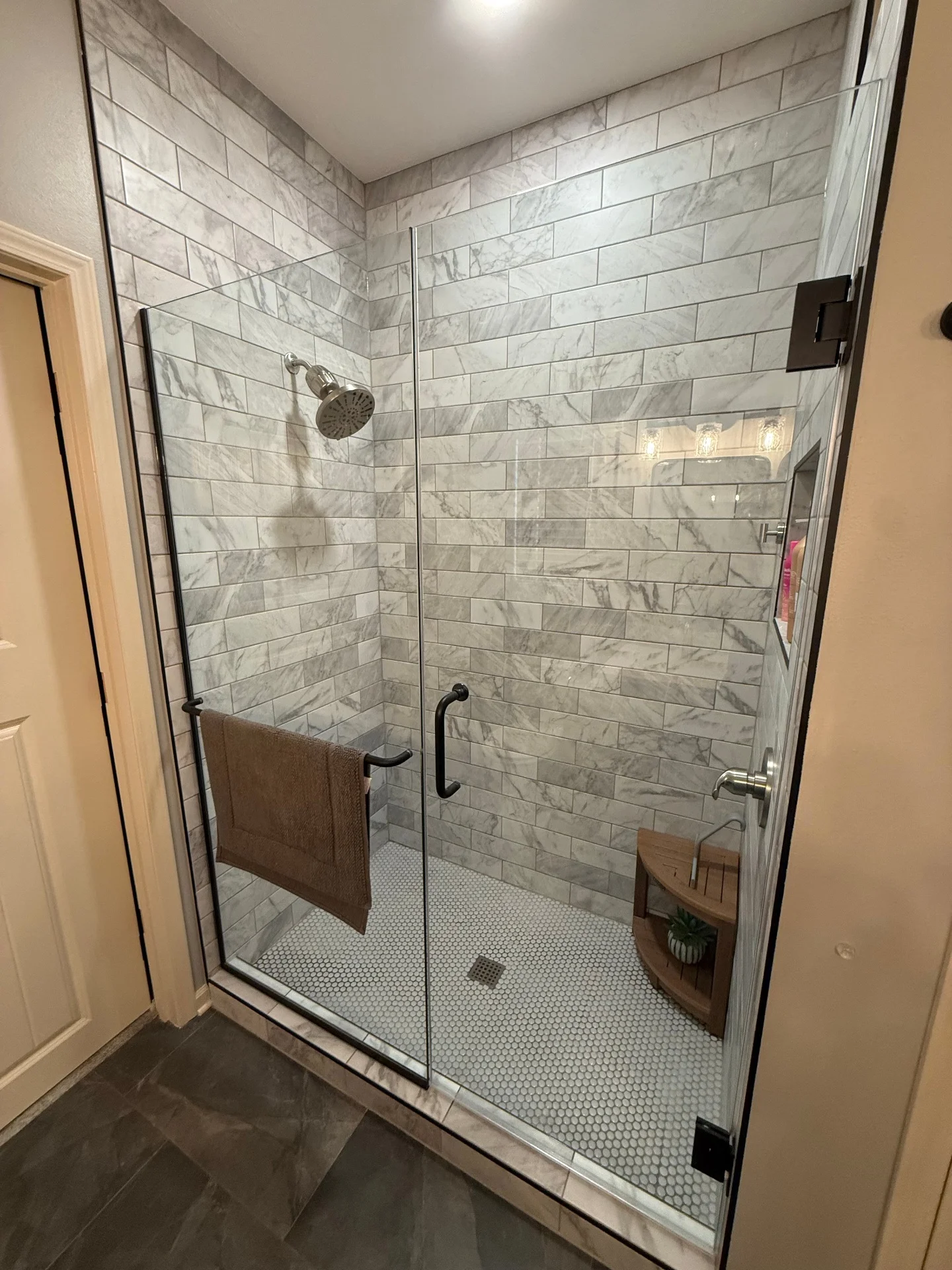 Residential bathroom remodel with walk-in tile shower and modern vanity