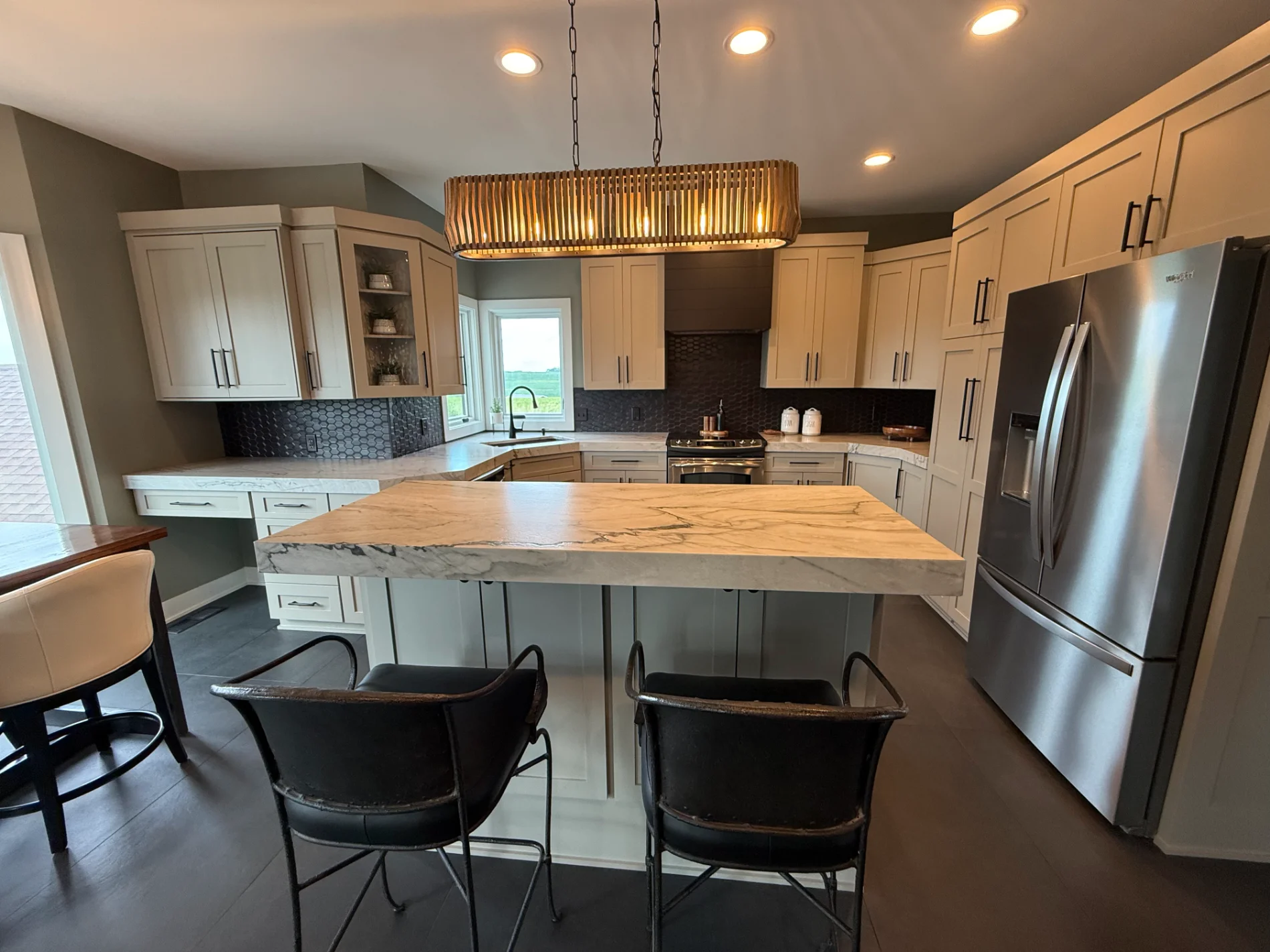 Finished kitchen remodel with white shaker cabinets and quartz island